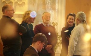 A photo showing a group of singing smiling and chatting during the break. 